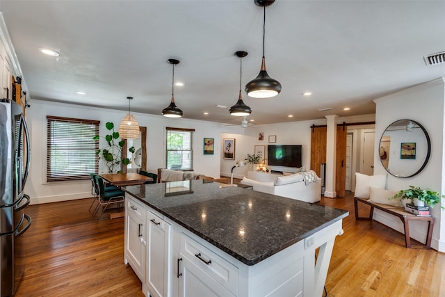 9923 Harwell Dr, Dallas, TX 75220 - kitchen featuring freestanding refrigerator, white cabinetry, recessed lighting, light wood-style floors, and open floor plan