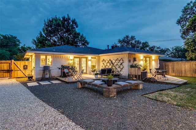 9923 Harwell Dr, Dallas, TX 75220 - back of property with a deck, brick siding, french doors, and a gate