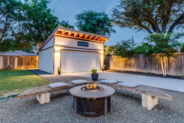 9923 Harwell Dr, Dallas, TX 75220 - view of patio / terrace with an outdoor fire pit, an outbuilding, and a garage