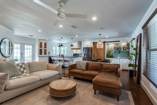 9923 Harwell Dr, Dallas, TX 75220 - living area with dark wood-style floors, crown molding, recessed lighting, ceiling fan, and french doors