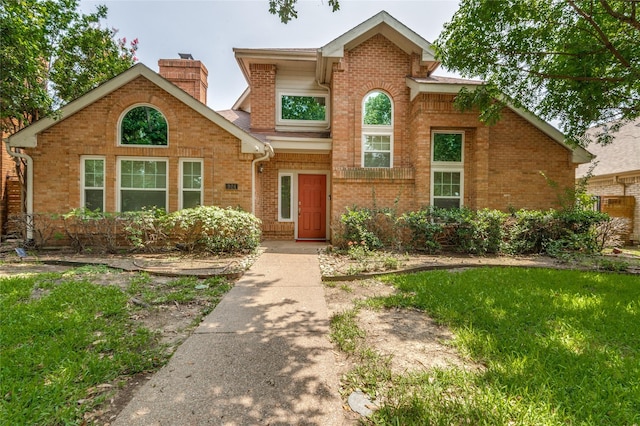 924 Mccoy Dr, Irving, TX 75062 - traditional-style home featuring brick siding and a chimney