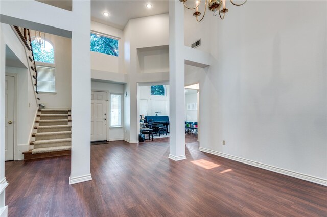 924 Mccoy Dr, Irving, TX 75062 - entrance foyer with a chandelier, stairway, wood finished floors, baseboards, and a high ceiling