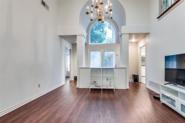 924 Mccoy Dr, Irving, TX 75062 - living area featuring a towering ceiling, dark wood-style flooring, a chandelier, arched walkways, and baseboards