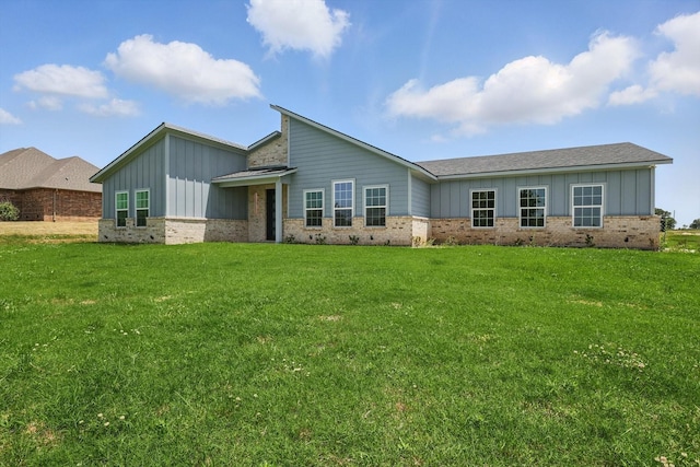 732 County Road 3424, Bridgeport, TX 76426 - view of front of home with board and batten siding, brick siding, and a front lawn