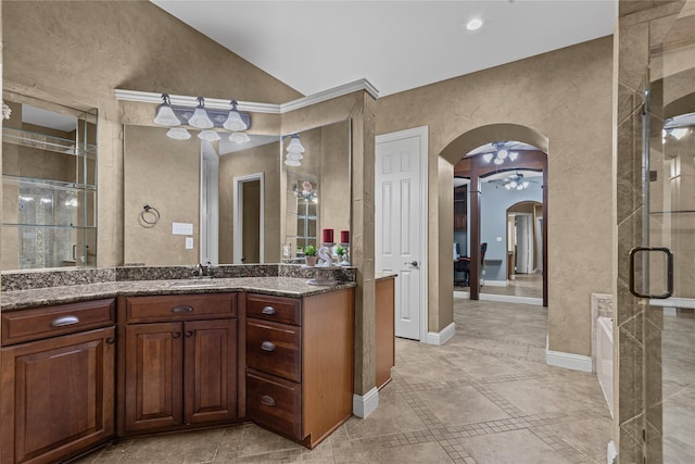 2959 Bandera, Grand Prairie, TX 75054 - bathroom featuring lofted ceiling, vanity, a shower stall, a bath, and baseboards