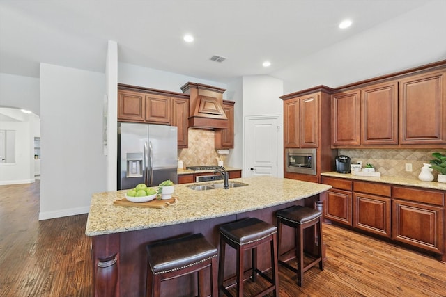 4324 Ashburn Way, Fort Worth, TX 76244 - kitchen with appliances with stainless steel finishes, custom range hood, a sink, arched walkways, and dark wood-style flooring