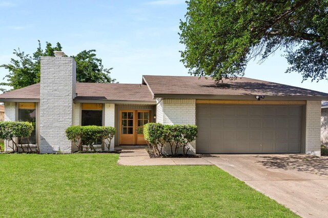 4028 Buckwheat St, Fort Worth, TX 76137 - view of front of property with brick siding, concrete driveway, a garage, and a front lawn