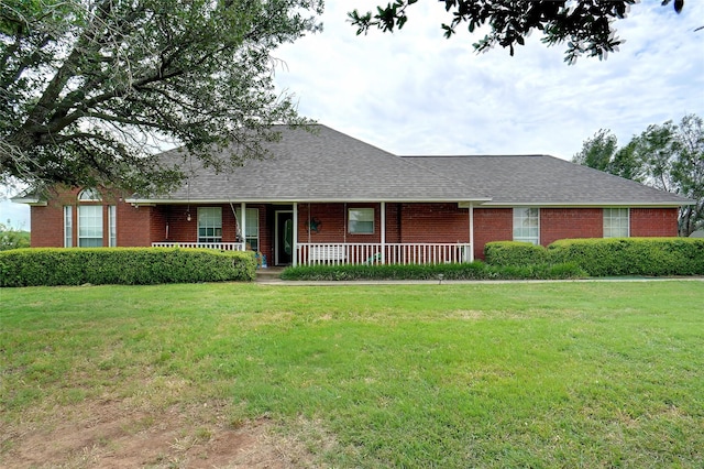 6813 Gregg Rd, Krum, TX 76249 - ranch-style home with covered porch, a front lawn, a shingled roof, and brick siding