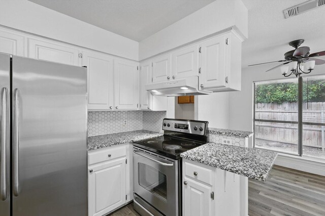 7616 Teresa Ct, North Richland Hills, TX 76182 - kitchen featuring appliances with stainless steel finishes, under cabinet range hood, ceiling fan, white cabinets, and light wood-style floors