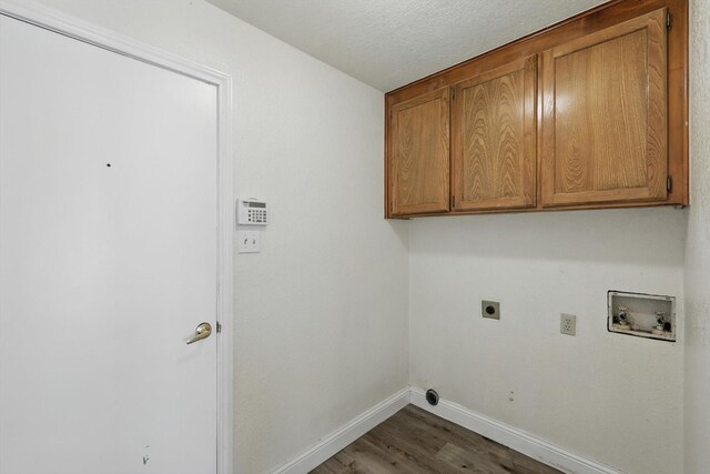 7616 Teresa Ct, North Richland Hills, TX 76182 - laundry area featuring washer hookup, cabinet space, baseboards, electric dryer hookup, and wood finished floors