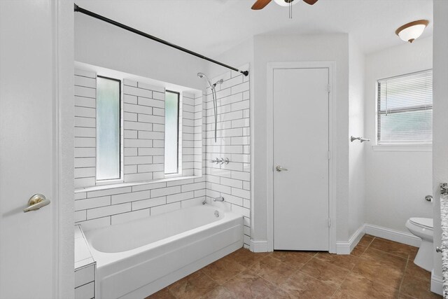7616 Teresa Ct, North Richland Hills, TX 76182 - full bath featuring washtub / shower combination, toilet, a ceiling fan, baseboards, and tile patterned flooring