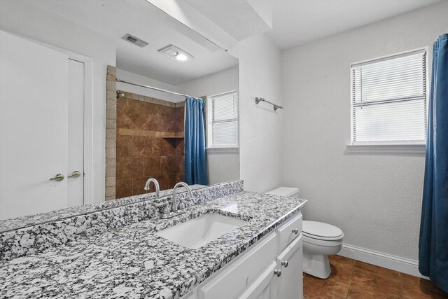7616 Teresa Ct, North Richland Hills, TX 76182 - bathroom with toilet, plenty of natural light, vanity, and a tile shower