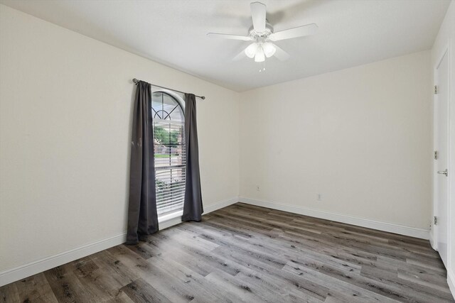 7616 Teresa Ct, North Richland Hills, TX 76182 - unfurnished room with wood finished floors, a ceiling fan, and baseboards