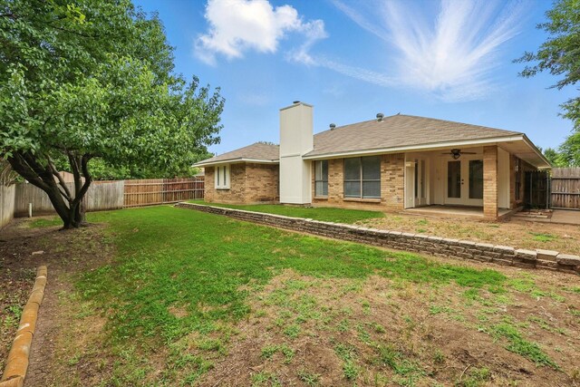 7616 Teresa Ct, North Richland Hills, TX 76182 - back of property featuring french doors, a chimney, brick siding, and a ceiling fan
