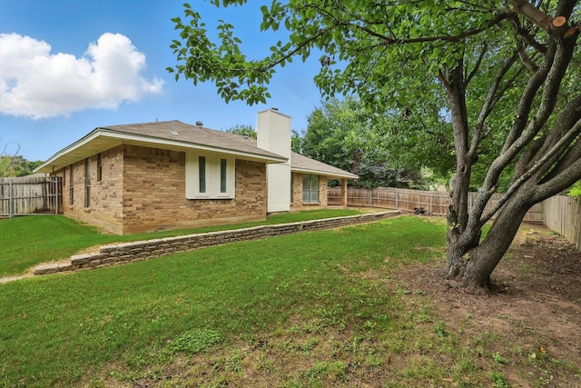 7616 Teresa Ct, North Richland Hills, TX 76182 - back of house with a chimney and brick siding