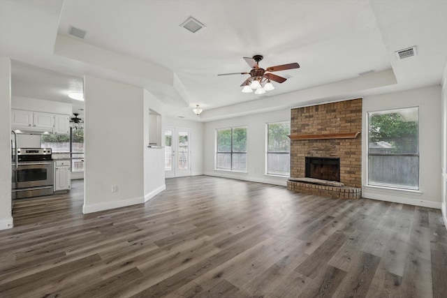 7616 Teresa Ct, North Richland Hills, TX 76182 - unfurnished living room featuring a ceiling fan, dark wood-style floors, baseboards, and a fireplace
