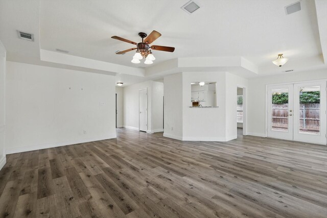 7616 Teresa Ct, North Richland Hills, TX 76182 - unfurnished living room featuring a ceiling fan, wood finished floors, a tray ceiling, and french doors
