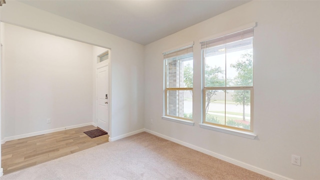 15941 Bronte Ln, Fort Worth, TX 76247 - empty room with healthy amount of natural light, baseboards, and light colored carpet