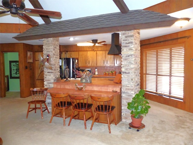 135 Lakeview, Brady, TX 76825 - dining space with ornate columns, carpet flooring, wood walls, a ceiling fan, and bar area
