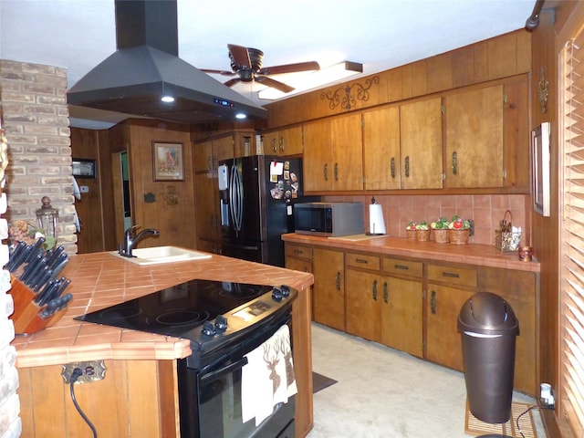 135 Lakeview, Brady, TX 76825 - kitchen with tile countertops, black appliances, island range hood, a sink, and backsplash