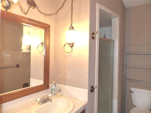 135 Lakeview, Brady, TX 76825 - bathroom with toilet, vanity, and a shower stall