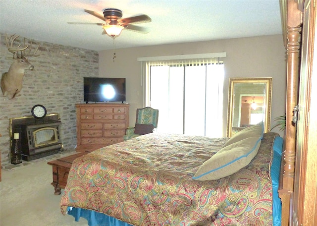 135 Lakeview, Brady, TX 76825 - carpeted bedroom featuring a wood stove and a ceiling fan