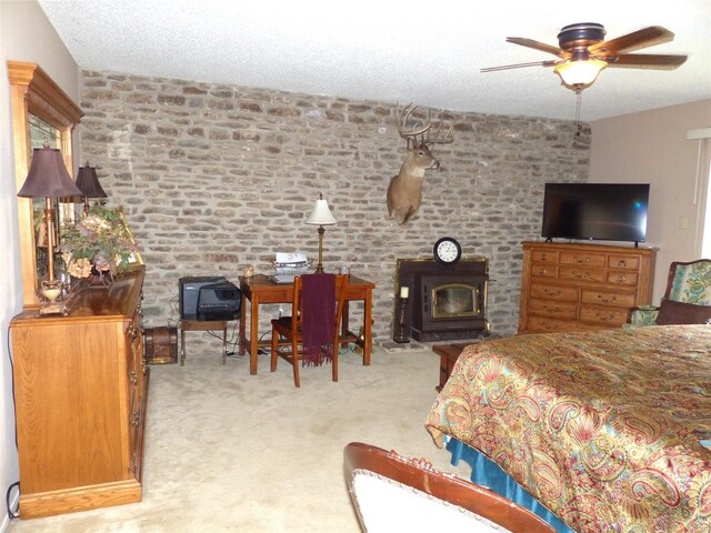 135 Lakeview, Brady, TX 76825 - bedroom with a wood stove and carpet floors