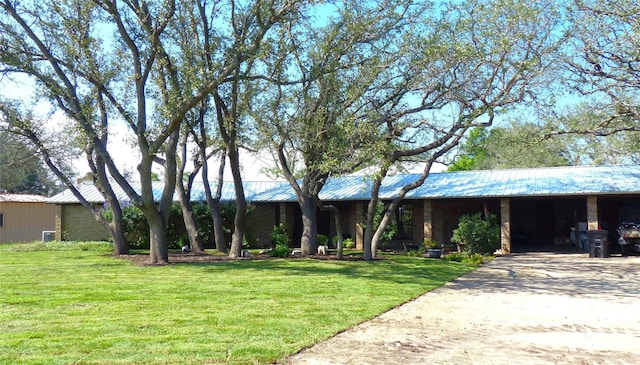 135 Lakeview, Brady, TX 76825 - single story home with metal roof, a front yard, and driveway