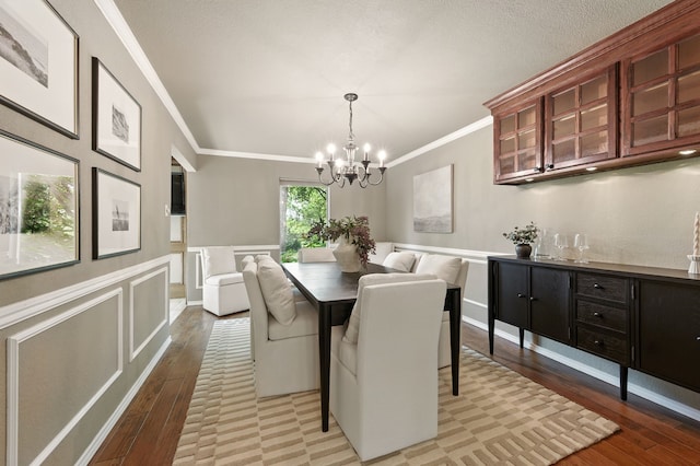 1610 Ottinger Rd, Keller, TX 76262 - dining room featuring ornamental molding, a chandelier, light wood-style floors, a wainscoted wall, and a decorative wall