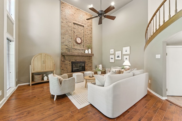 1610 Ottinger Rd, Keller, TX 76262 - living room featuring high vaulted ceiling, ceiling fan, wood finished floors, a fireplace, and arched walkways
