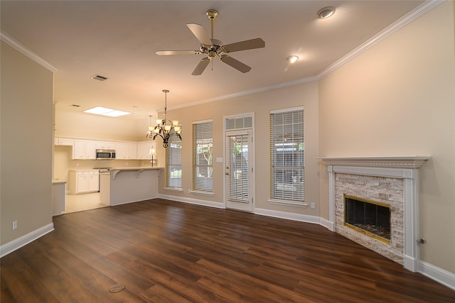 108 Arbor Ln, Shreveport, LA 71115 - unfurnished living room with crown molding, a stone fireplace, a chandelier, dark wood-style floors, and baseboards