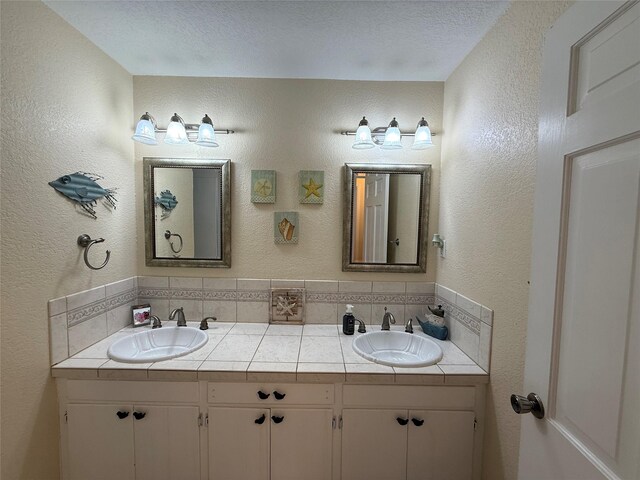 4 Preston Pl, Mineral Wells, TX 76067 - bathroom featuring double vanity and a textured wall