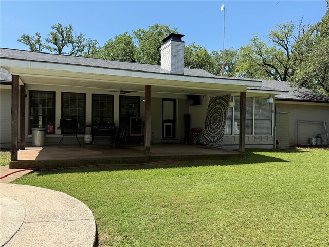 4 Preston Pl, Mineral Wells, TX 76067 - rear view of property featuring a lawn, a chimney, and a patio area