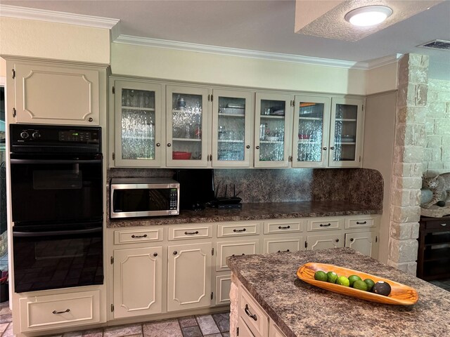 4 Preston Pl, Mineral Wells, TX 76067 - kitchen with stainless steel microwave, crown molding, glass insert cabinets, decorative backsplash, and dark stone countertops