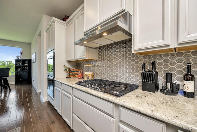 3413 Meridian Dr, Northlake, TX 76226 - kitchen with appliances with stainless steel finishes, extractor fan, dark wood finished floors, decorative backsplash, and white cabinets