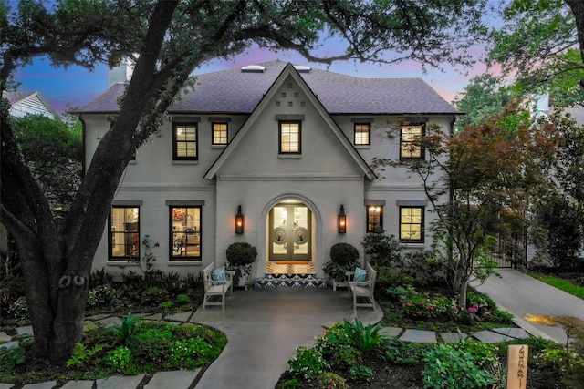 4561 Bordeaux Ave, Highland Park, TX 75205 - view of front of house featuring roof with shingles, a chimney, french doors, and brick siding