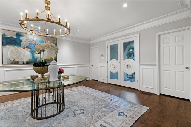 4561 Bordeaux Ave, Highland Park, TX 75205 - entrance foyer with french doors, a chandelier, crown molding, wood finished floors, and a wainscoted wall