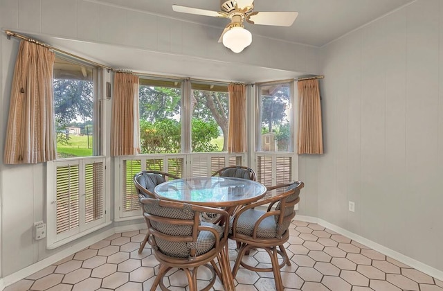 2832 Wooded Acres Dr, Waco, TX 76710 - dining area with a ceiling fan, baseboards, light tile patterned floors, and crown molding