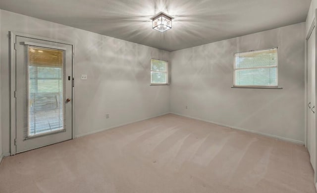 2832 Wooded Acres Dr, Waco, TX 76710 - spare room with light colored carpet, healthy amount of natural light, and baseboards