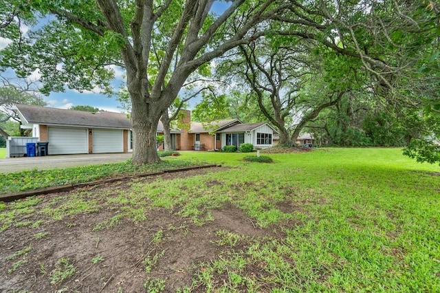 2832 Wooded Acres Dr, Waco, TX 76710 - view of front facade with driveway, a garage, a front lawn, and brick siding