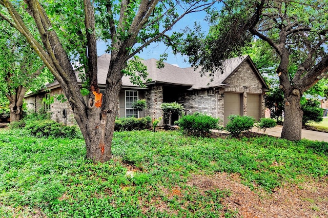 7536 Meadow Creek Dr, Fort Worth, TX 76123 - view of front of house featuring brick siding, a garage, roof with shingles, and driveway