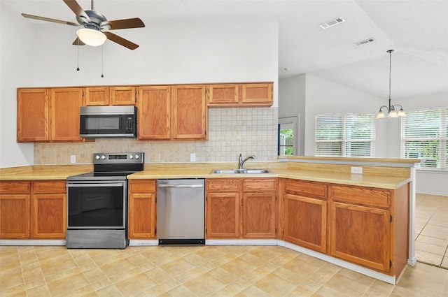 7536 Meadow Creek Dr, Fort Worth, TX 76123 - kitchen featuring appliances with stainless steel finishes, a sink, vaulted ceiling, decorative backsplash, and light countertops
