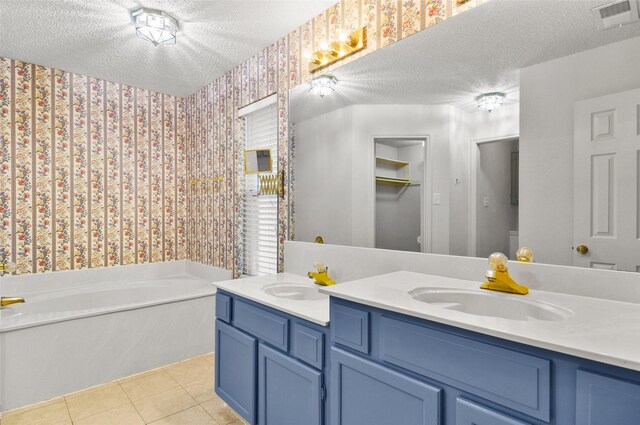7536 Meadow Creek Dr, Fort Worth, TX 76123 - full bathroom with wallpapered walls, a textured ceiling, double vanity, a garden tub, and tile patterned floors