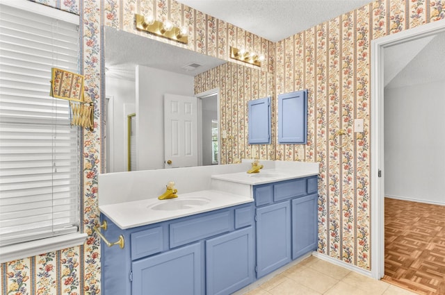 7536 Meadow Creek Dr, Fort Worth, TX 76123 - full bath featuring baseboards, double vanity, a textured ceiling, and wallpapered walls