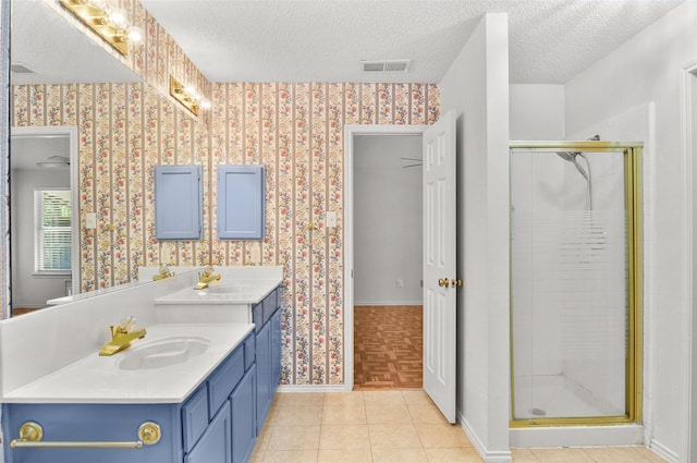 7536 Meadow Creek Dr, Fort Worth, TX 76123 - bathroom with a textured ceiling, vanity, baseboards, a shower stall, and wallpapered walls