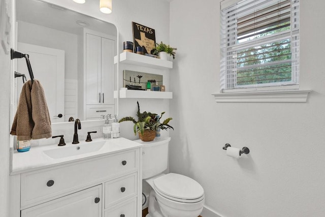 208 E 7th St, Prosper, TX 75078 - half bathroom with toilet, vanity, and baseboards