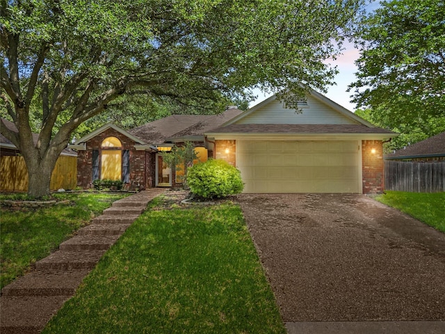 2008 Real Dr, Waco, TX 76712 - ranch-style home featuring asphalt driveway, brick siding, and an attached garage