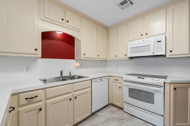 2008 Real Dr, Waco, TX 76712 - kitchen with white appliances, a sink, cream cabinets, light marble finish floors, and light countertops
