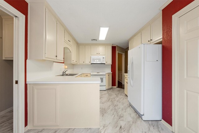 2008 Real Dr, Waco, TX 76712 - kitchen with white appliances, a sink, a peninsula, cream cabinetry, and baseboards