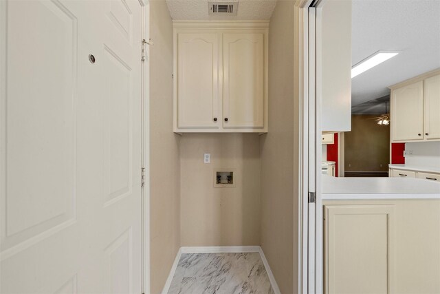 2008 Real Dr, Waco, TX 76712 - laundry area featuring hookup for a washing machine, baseboards, light marble finish floors, and cabinet space